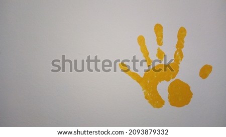 handprint on the wall with yellow paint