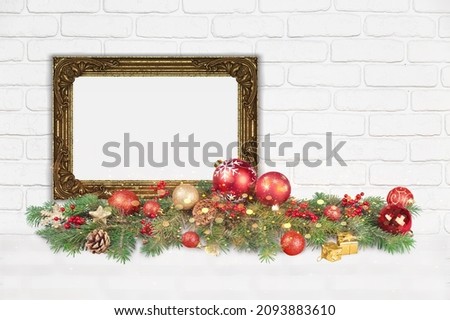 A beautiful empty frame, and Christmas garland with decorations in white wall