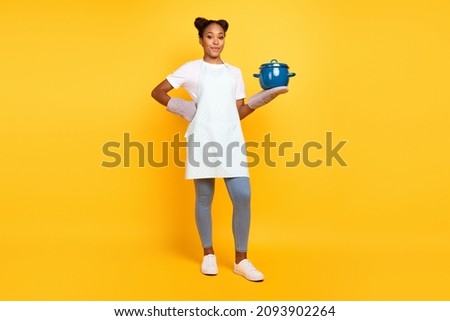 Full body photo of young african woman cook dinner healthy diet calories eat isolated over yellow color background Royalty-Free Stock Photo #2093902264