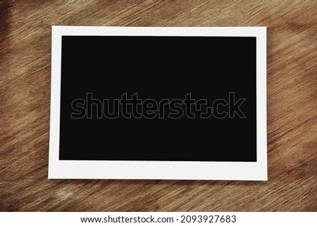 Picture frame mockup design. Empty photo on wooden background.