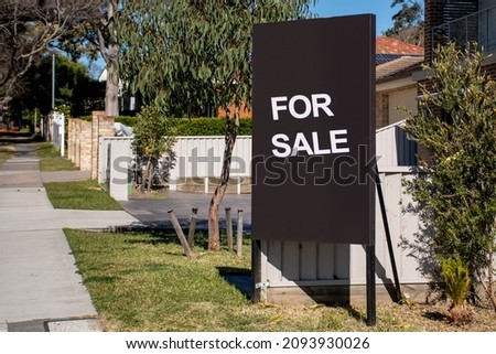 For sale sign on black board near the resedential building. Property Real estate concept
