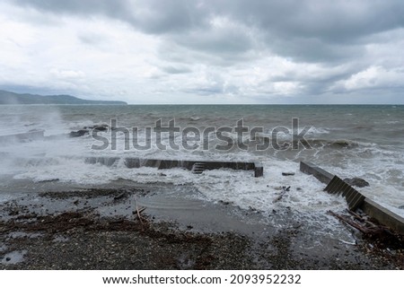 storm on the black sea, waves crashing on the shore, brown water