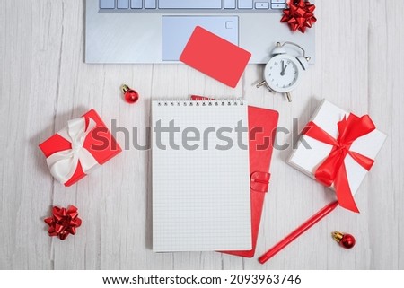 Christmas composition. Notepad with goals for 2021. Laptop, pen, gift boxes, letter envelopes, balls and stars. Concept business Christmas. Goals and objectives. High quality photo
