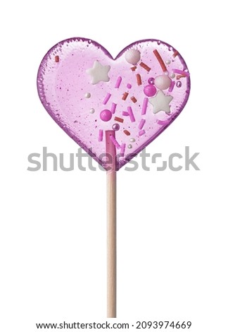 Front view of pink transparent heart shaped lollipop with sprinkles isolated on a white