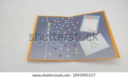 Handmade origami paper craft red, yellow, purple, blue, green Christmas tree cards greetings isolated on white