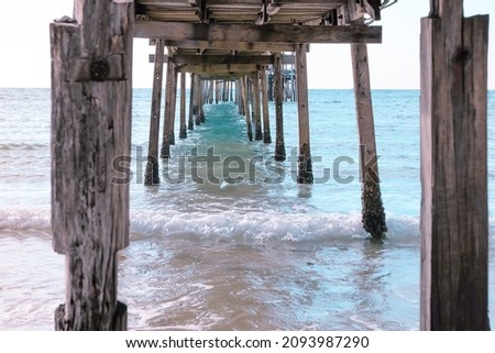 Selective focus,Under the wooden bridge on sea beach soft wave