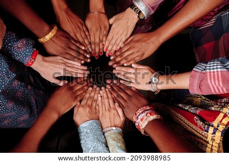 Hands of a group of multinational people which stay together in circle. Royalty-Free Stock Photo #2093988985