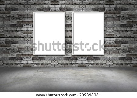 white frame on a brick wall and the concrete floor