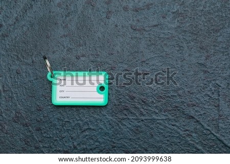 Plastic key tag on dark background