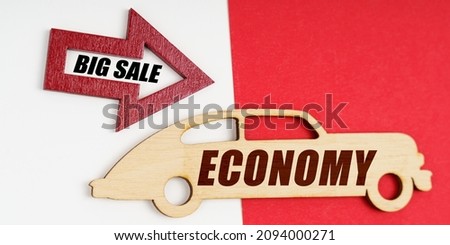 Business and economy concept. On a white and red background, a car and an arrow with the inscription - BIG SALE