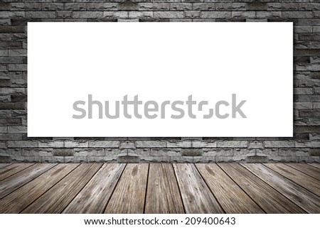 white frame on a brick wall and the wooden floor