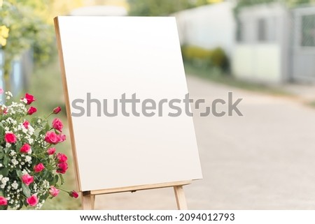 A blank white display board placed for celebration with an empty space for messages.