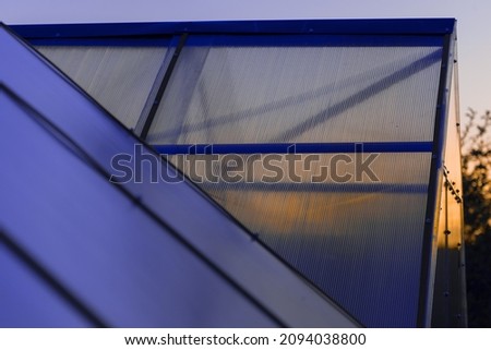 the roof of the greenhouse made of cellular polycarbonate at sunset