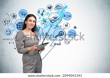 Smiling young attractive businesswoman wearing formal dress is holding tablet device. Sketch with globe, smartphone, search, web in the background. Concept of imagination and inspiration
