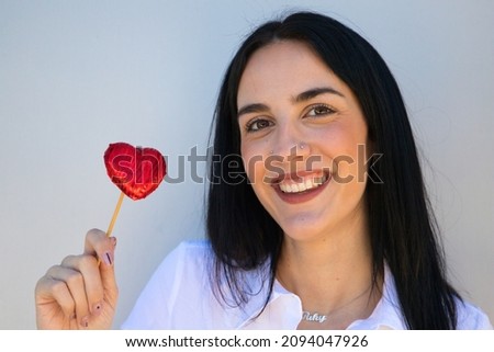 Beautiful young woman with Valentine's heart-shaped details on her hands. Concept of love. Beautiful smiling young woman. Valentine's day gift. Isolated on white background.