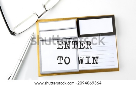 ENTER TO WIN text on the sticky notes with glasses and pen, business concept