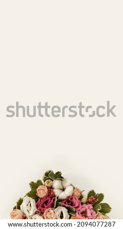 Closeup of bouquet of flowers in rustic style on white background. Vertical for stories. Copy space. Spring flowers from bottom. Bouquet element.