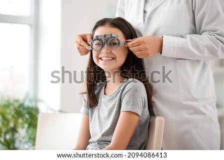 Little girl undergoing eye test in clinic Royalty-Free Stock Photo #2094086413