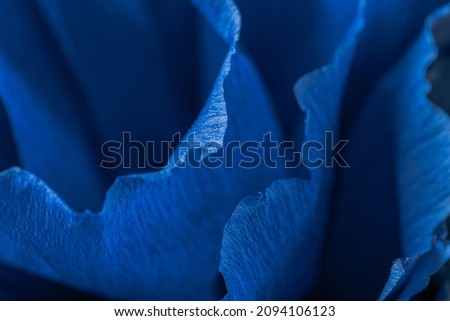 Fragment of a blue flower made of crepe paper. Blurred background. Soft selective focus