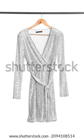 Hanger with stylish female dress on white background