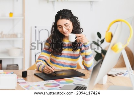 Graphic designer working in office Royalty-Free Stock Photo #2094117424