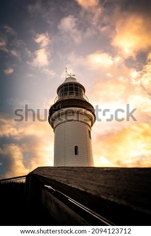 The beautiful white lighthouse in Byron Bay, NSW, Australia at sunset. Royalty-Free Stock Photo #2094123712