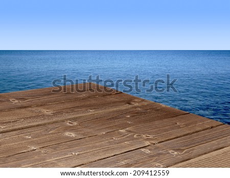 Wooden table corner with seascape background Royalty-Free Stock Photo #209412559