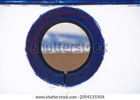 small lookout window over a boatman's boat, navy blue and white mediterranean tones, vintage