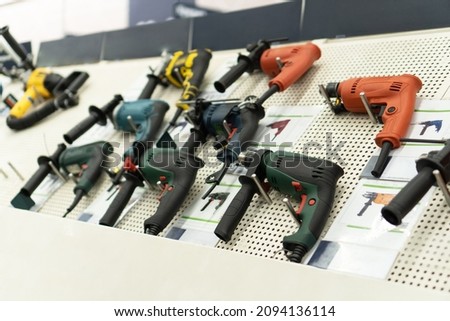 Showcase with power tool drills in hardware store. Royalty-Free Stock Photo #2094136114