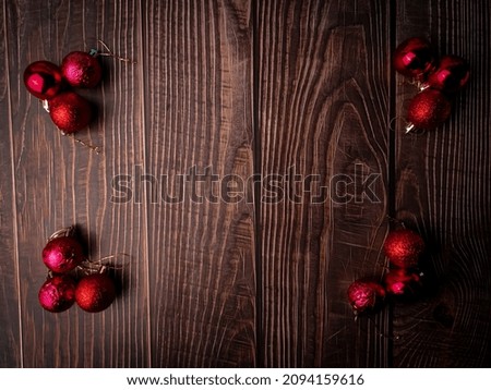 Christmas red ball on a wooden table. Holidays christmas background. Copy space for text or design. View from above.