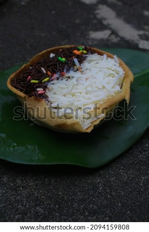 Martabak Manis Mini is Indonesian dessert. Sweet Martabak Bangka with chocolate, cheese. this picture in white background and blurry, selective object, with eight different toppings. Indonesian food.
