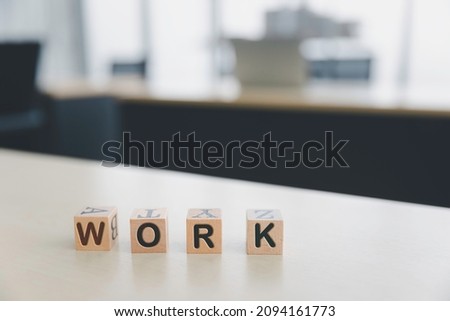 Work text on wooden cube box in office