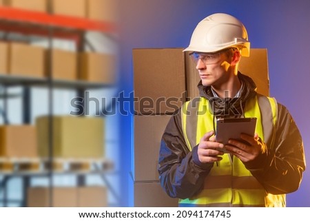 Man with a tablet on the background of a warehouse. Serious manager using a digital tablet while standing in a warehouse. Warehouse storage of goods and finished products. Storekeeper in yellow vest Royalty-Free Stock Photo #2094174745