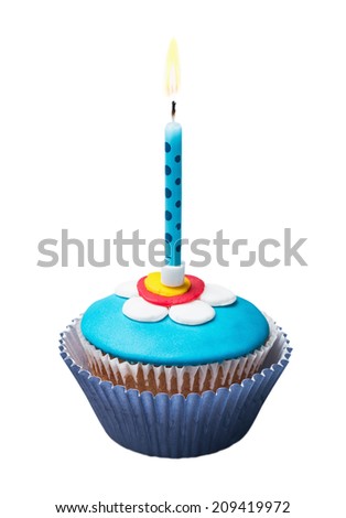 Burning candle on the cupcakes with decorations of mastic on a white background