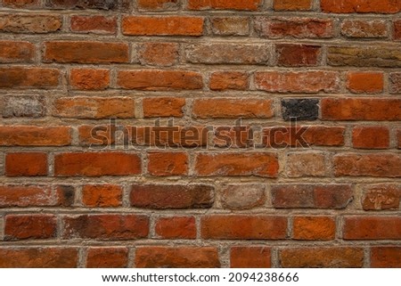 Photo of a small section of an old and worn brick wall, texture close-up