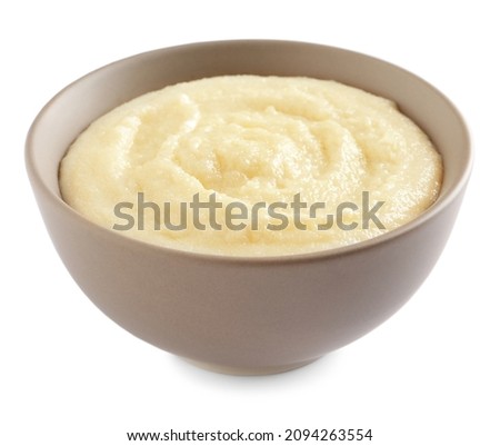 Bowl with delicious semolina pudding on white background Royalty-Free Stock Photo #2094263554