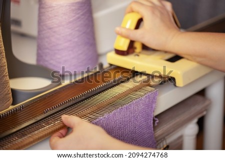 Womans hands working with knitting machine, knitting as womans hobbies. Small Business concept