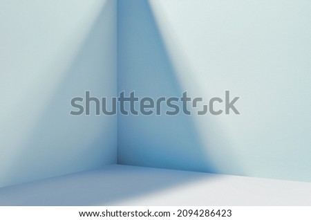 Light soft minimal background mockup for product presentation. Corner of room with shadows from different angles delicate light blue color. Royalty-Free Stock Photo #2094286423