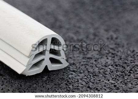 close-up of grey color rubber dilation profile, black background Royalty-Free Stock Photo #2094308812