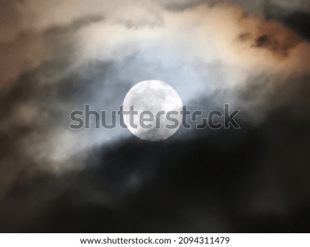 picture of the full moon with clouds at night