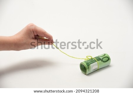 hand pulling money like bait on a rope