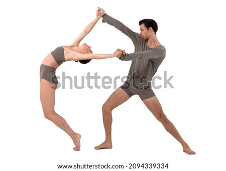 Couple of modern ballet dancers dancing on white background 