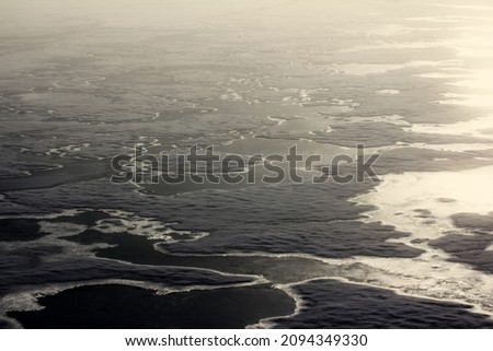Contour aerial images of Arctic ice at a latitude of 87-88 degrees in the summer. Melting of polar ice in the Arctic Ocean, many melt water pools Royalty-Free Stock Photo #2094349330