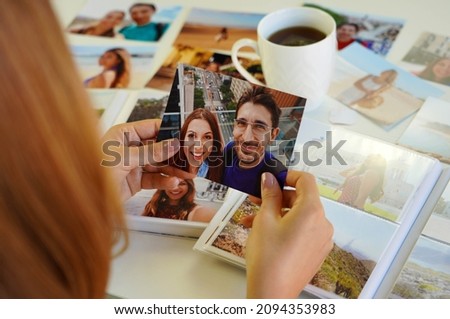 Romantic woman looking at image prints with her boyfriend at home