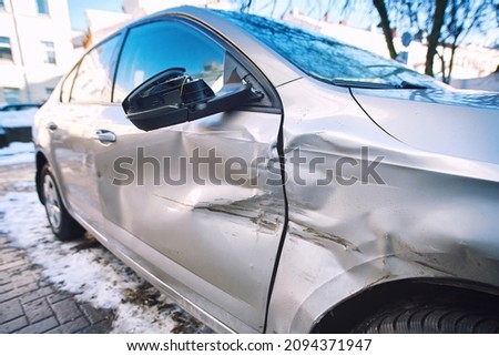 Car body side damage, traffic accident in winter season. Car door damage, broken and damaged side mirror on car door. Royalty-Free Stock Photo #2094371947