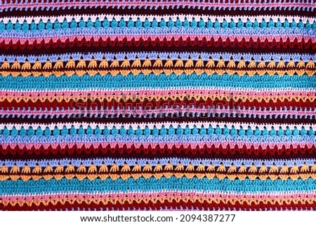 Crochet texture of colored striped knitted fabric Royalty-Free Stock Photo #2094387277
