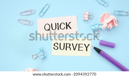Quick Survey text written on are two papers with pencils