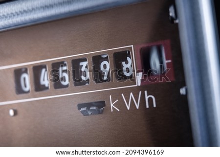 Close up of electricity meter with rotating digit. Royalty-Free Stock Photo #2094396169