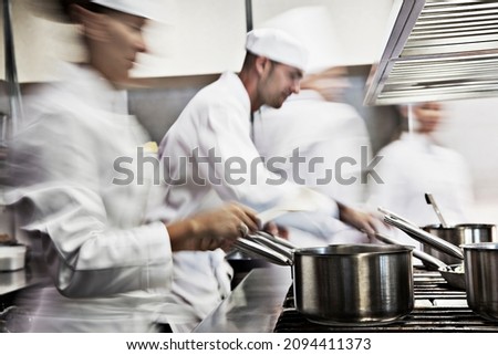 Chefs cooking in restaurant kitchen