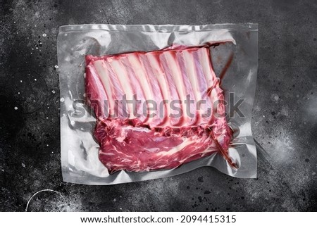 Lamb rib pack set, on black dark stone table background, top view flat lay Royalty-Free Stock Photo #2094415315